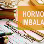 A photo of a clipboard with the words hormonal imbalance on it.